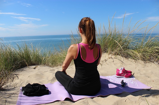 woman meditating on beach