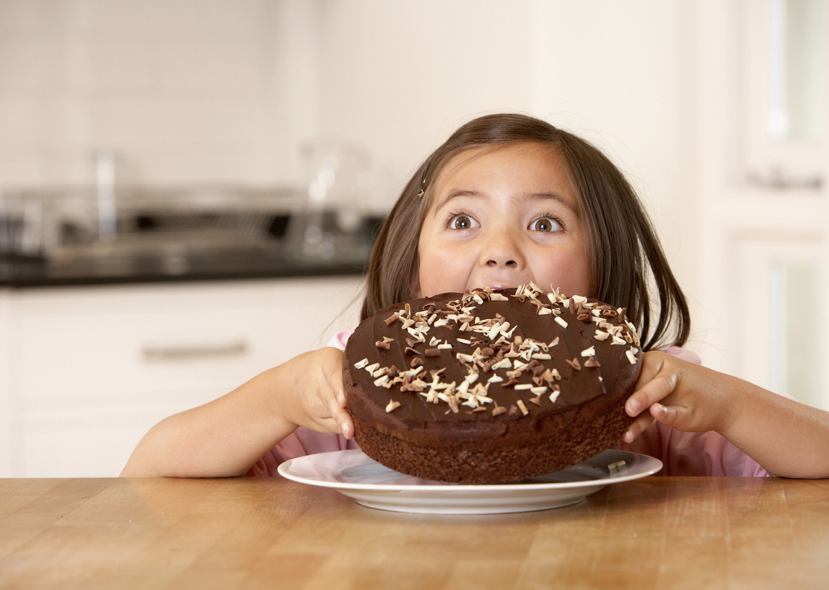 child eating chocolate cake